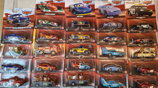 Collection of toy cars in display cases on a table.