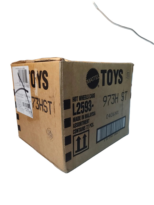 Cardboard box with Mattel Toys branding on a surface with a brick wall background