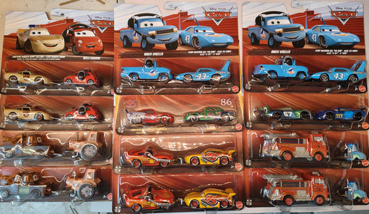 Collection of toy car packages from the 'Cars' franchise on a table.