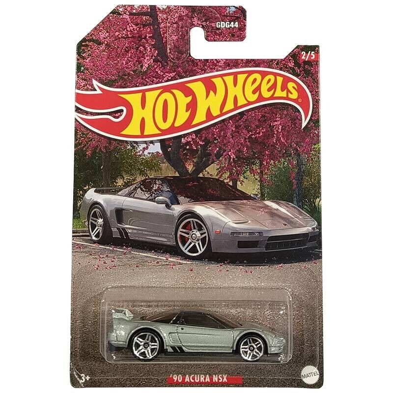 A Hot Wheels 1:64 Walmart Exclusive Theme JDM package features a silver ’90 Acura NSX, with the real car pictured under pink blossoms and the Hot Wheels logo plus ’90 Acura NSX labeled on the card.